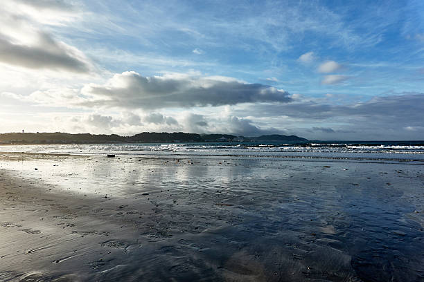 istock Scenic view of beach against dramatic sky during sunrise 2230378591