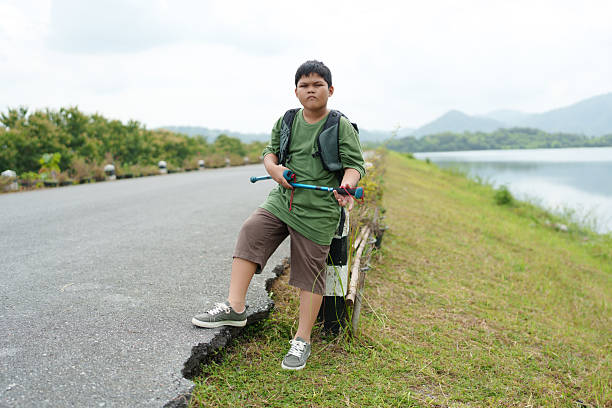 A boy walks through the forest to study natural resources.