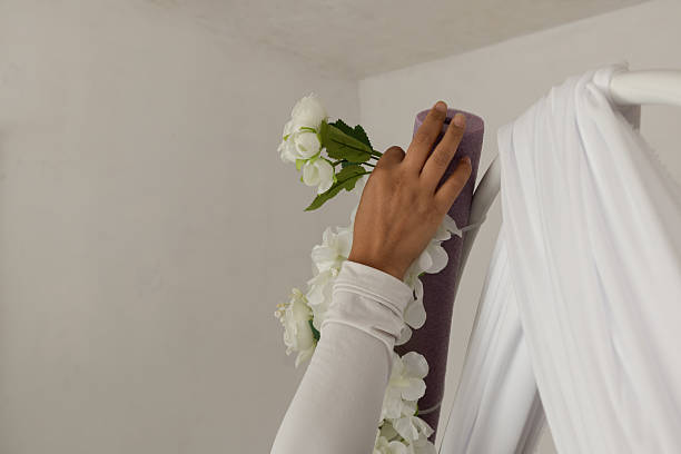 istock Entrepreneur decorating workplace with flowers and curtains 2230380600
