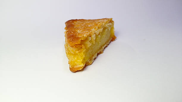 istock Slice of Classic Lemon Pie with Golden Crust on White Background 2230382557