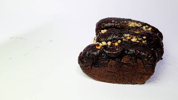istock Chocolate Biscuit with Nut Topping on White Background 2230382684