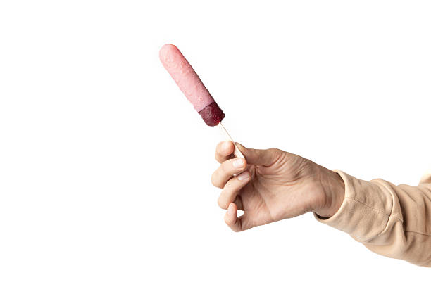 Minimalist food photo of hand holding popsicle ice cream on white background.