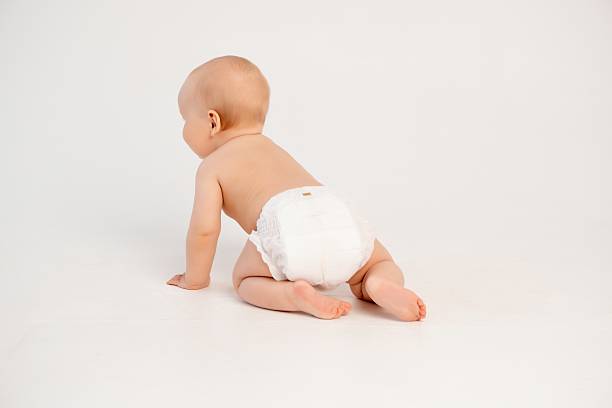 istock baby in diapers crawling, little boy on a white isolated background learning to crawl in diapers, space and room for text 2230385209