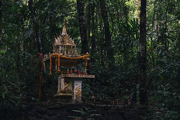 istock Small buddhist shrine standing in a forest in Thailand 2230385839