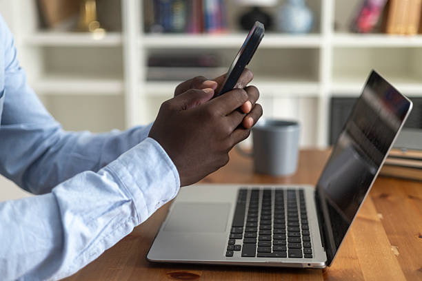 istock Businessman working from home using smartphone and laptop 2230386585
