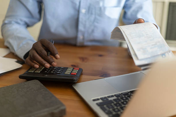 istock Accountant using calculator and laptop to check invoice and plan budget 2230387049