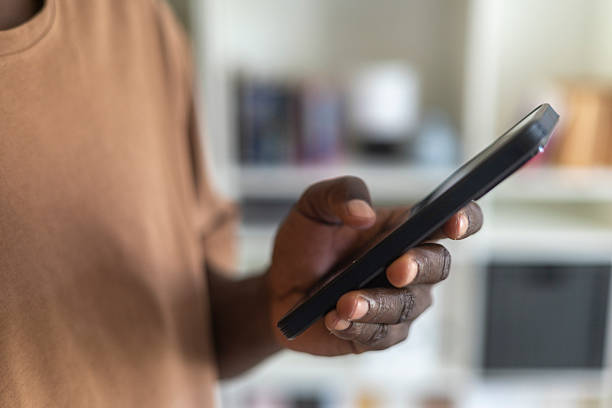 istock Close-up of a young man using smartphone 2230387405
