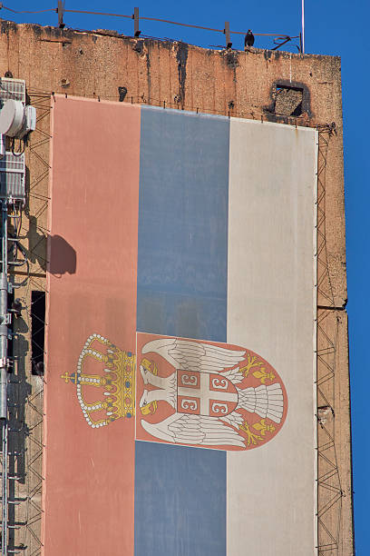 istock Huge Serbian flag on a building with a blue sky background 2230394240