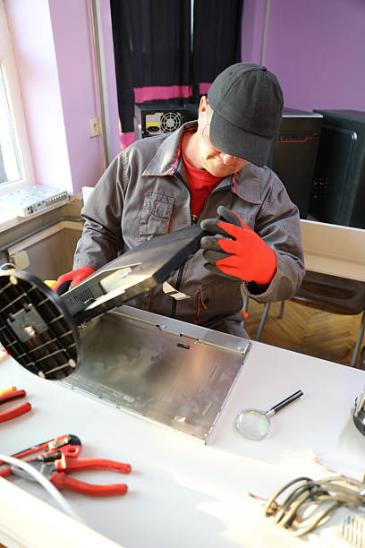 istock Mature Man In Protective Gear Fixing PC Screen In Workshop 2230396647
