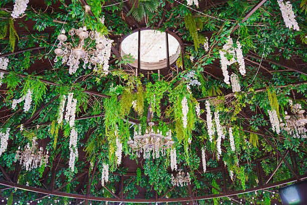 istock Unique chandelier arrangement among lush greenery in an elegant space 2230398269