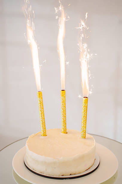 istock Festive cake with sparklers celebrating a special occasion in a bright setting 2230398693
