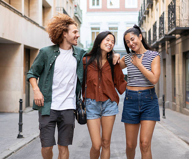 istock Three young adults walking down the street, laughing together 2230398710