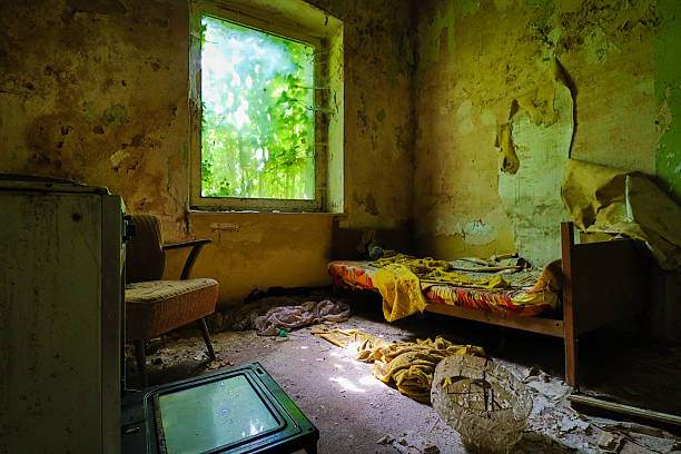 bed, stove and an old armchair inside a lost place