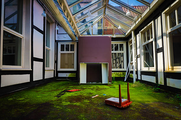 overgrown winter garden with glass of a lost place hotel