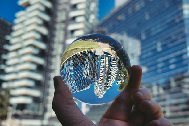 istock Hand holding crystal ball with skyscrapers background 2230402566