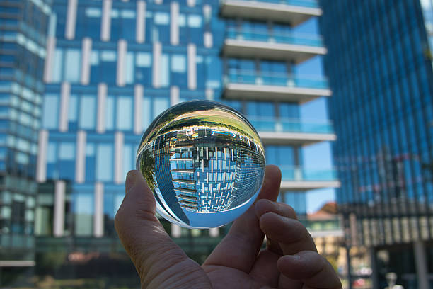 istock Hand holding crystal ball with skyscrapers background 2230402571