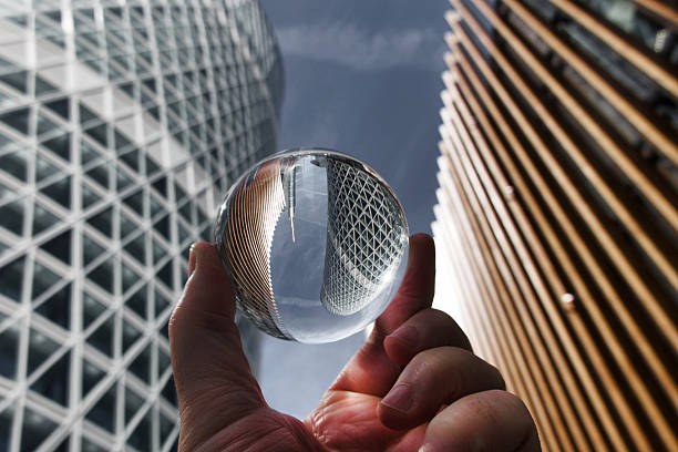 istock Hand holding crystal ball with skyscrapers background 2230402582