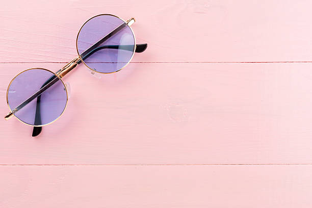 istock Blue sunglasses on wooden background, top view 2230402735