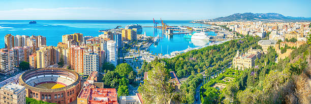 Panoramic view of Malaga featuring the iconic bullring, the harbor, and the historic cathedral, Spain