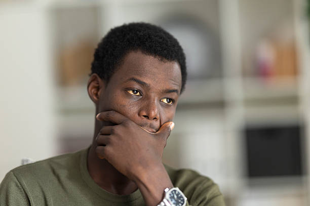 istock Pensive male deep in thought, hand resting on chin, contemplating with soft-focus environment behind him 2230406685