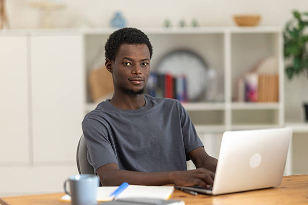 istock Concentrated african american professional working remotely, typing on laptop at home workspace 2230406834