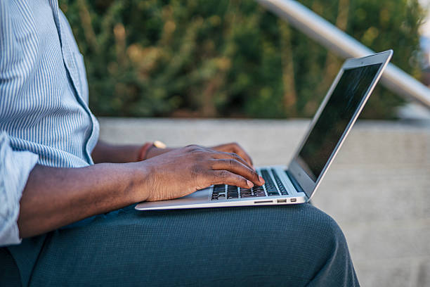 istock Businessman working on laptop outdoors in urban setting 2230407557
