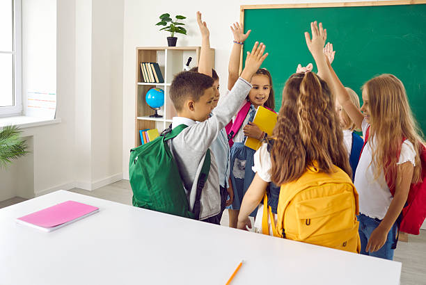 istock Elementary school students are having fun talking and raising their hands to vote. 2230407574