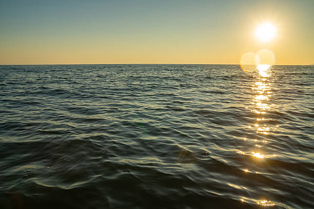 istock Golden sunset reflection on sea waves 2230410601