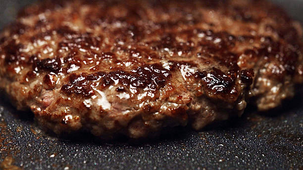 istock Frying beef patty in pan on stove. 2230413076