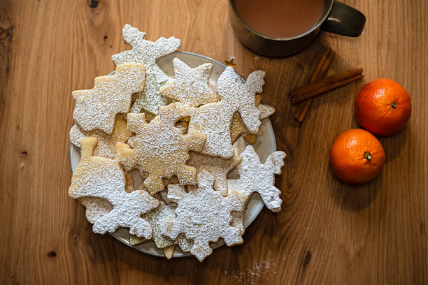 Delightful Christmas Cookies on a Festive Table with Warm Beverage and Oranges