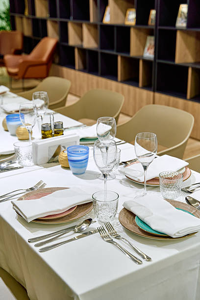 istock Elegant Dining Setup Showcasing a Tastefully Arranged Table with Fine Dishware, Glassware, and Centered Decorative Elements for a Memorable Culinary Experience 2230418766