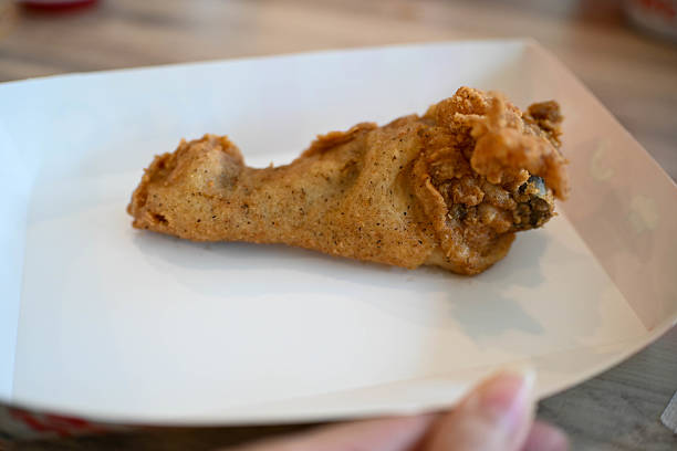 One wing crispy fried chicken, on white plate, isolated in white background, side view