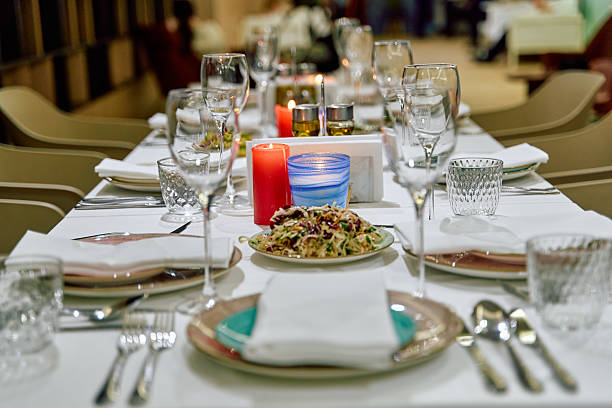 Elegant Dining Experience with Beautifully Set Table Featuring Gourmet Salad and Colorful Candles Creating an Inviting Ambiance for Guests
