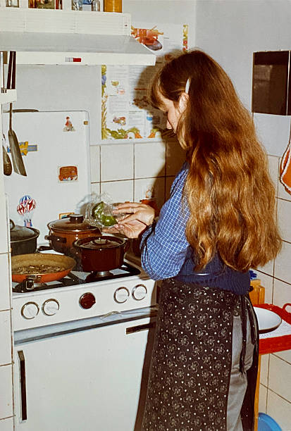 istock Young Woman preparing Dinner back in the Seventies. 2230423733