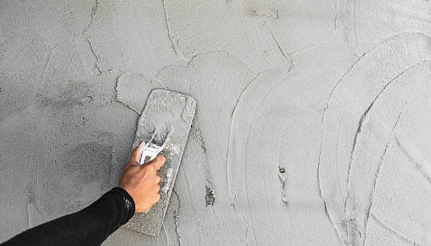 istock Hand worker plaster polish rough cement wall texture backgrounds 2230424611