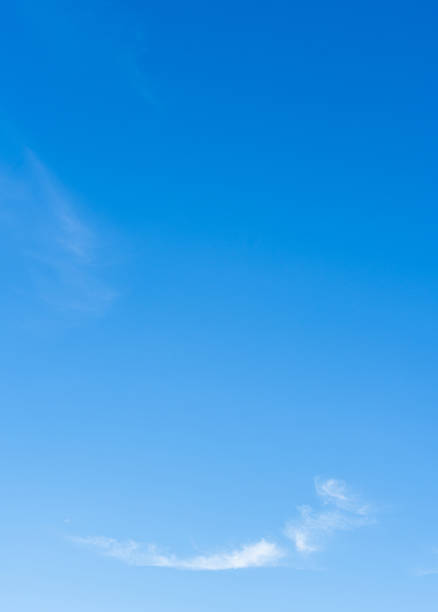 istock Blue sky white cloud vertical background, Minimal bright clouds sunny vibrant day light 2230426549