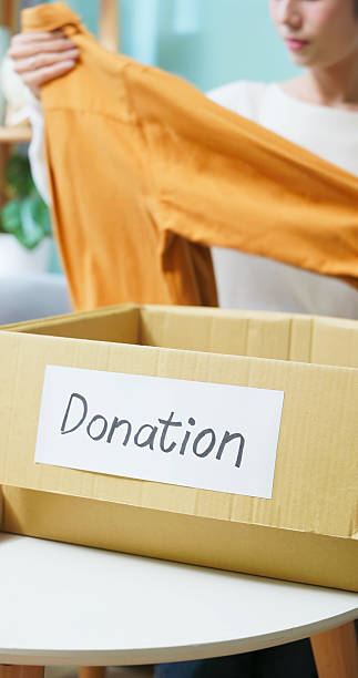 istock Woman Packing Donation clothes 2230431409