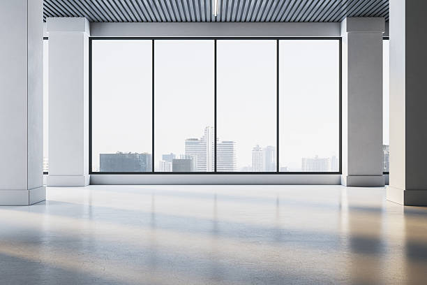 istock Modern empty office room with large city-view windows and sunlight reflections on the floor in a corporate building interior space concept. 3D Rendering 2230432222