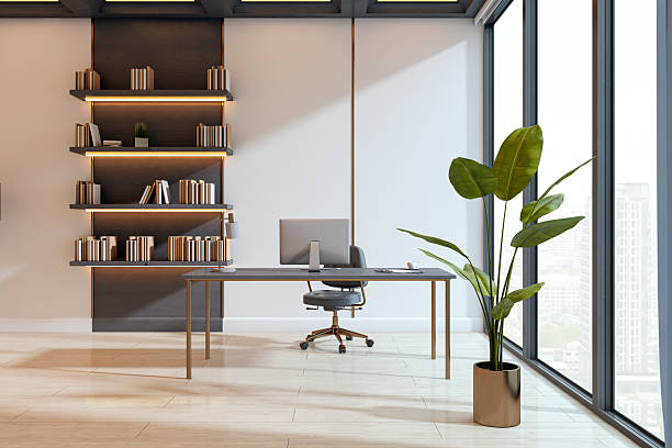 istock Modern minimalist office interior with computer desk, bookshelves, large windows, and potted plant in contemporary corporate workspace. 3D Rendering 2230432369