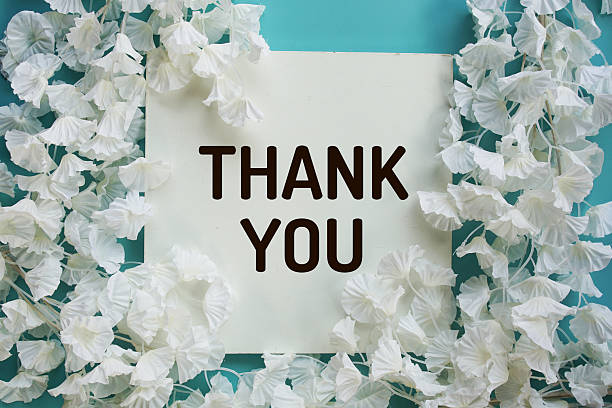 istock Thank You text with flowers frame decoration top view on blue background 2230436247