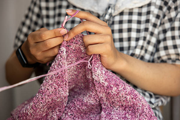 Young girl doing hand knitting