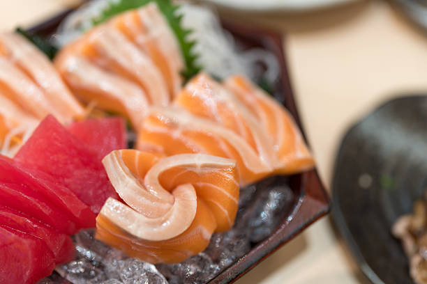 istock Raw salmon slices and raw tuna arranged on iced ready for eating. 2230440979