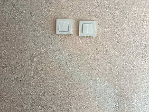 Front view electric lamp light switches on the wall with copy space