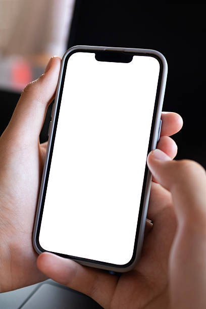 istock Hand Holding Smartphone with White Blank Screen in Modern Workspace 2230443522