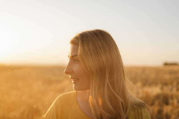 istock Golden-haired woman in a wheat field 2230443746