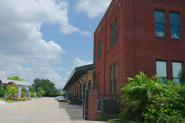 istock Old Brick Building With Greenery Next to a Sunny Pathway Under Blue Sky 2230446100