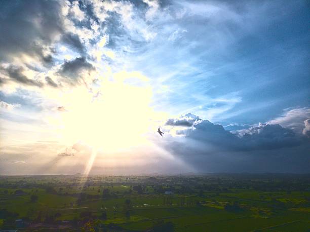 istock green landscape with the sun breaking through the clouds 2230448795