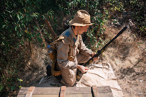 Historical reenactment soldier reloading rifle during world war ii event