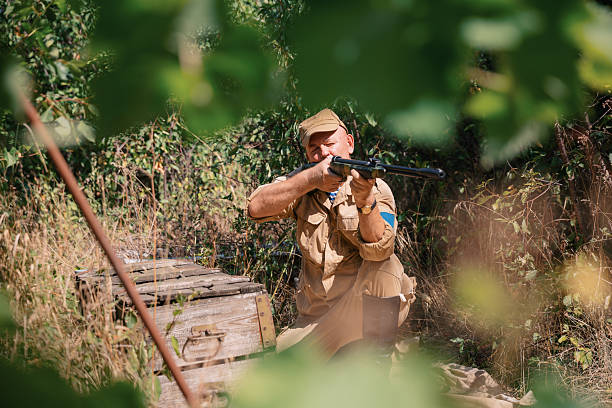 Liberation Camp : Showing  military  Photo and Film Camera from World War II. Part of an Unrecognizable person dressed in military uniform , from that time.