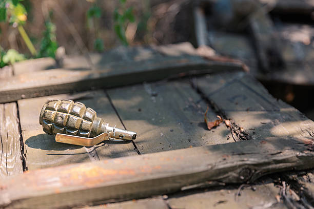 istock Hand grenade lying on a wooden crate in the forest 2230452356